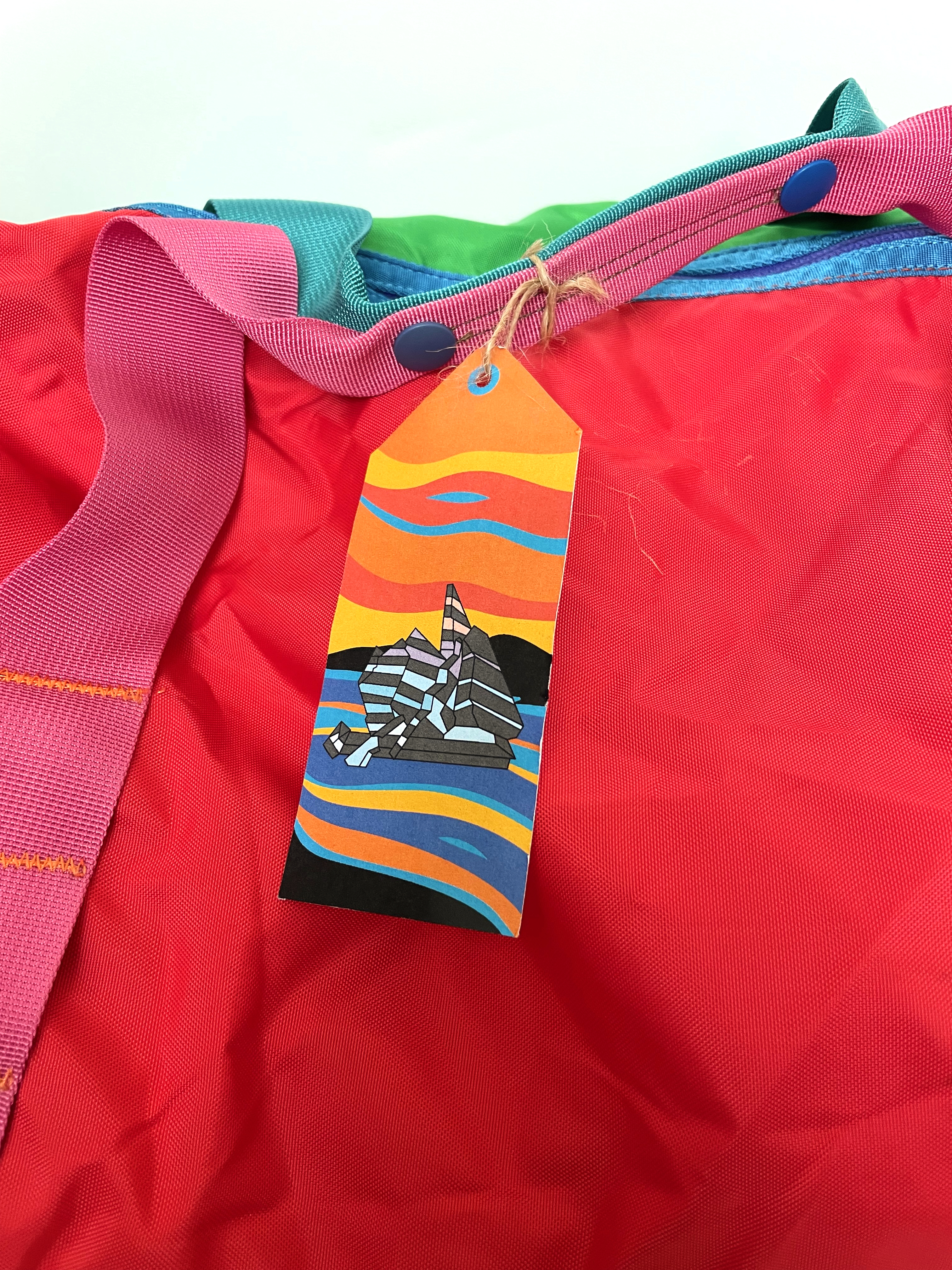 A printed luggage tage showing a vector-designed image of Oslofjord, Oslo,  Norway